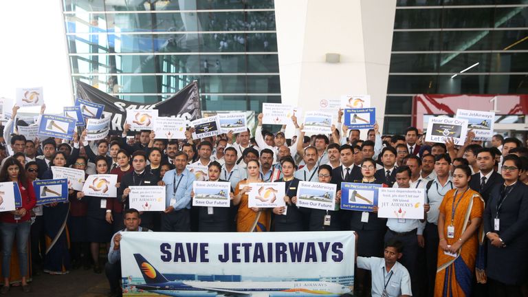 Jet Airways employees hold placards as they gather for a silent march at Terminal 3 of the Indira Gandhi International Airport, in New Delhi on April 13, 2019