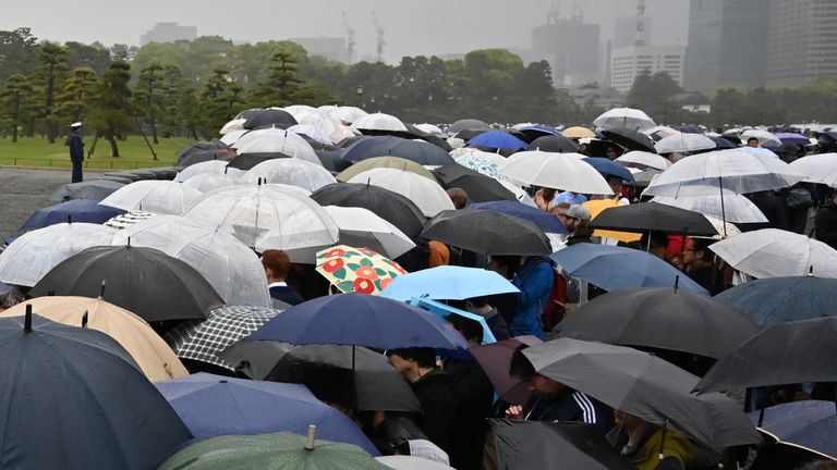 Hundreds stand outside the royal palace in Tokyo as the abdication takes place