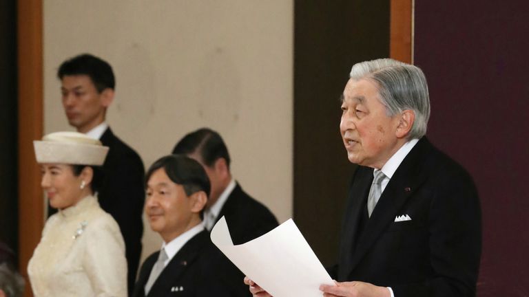 Japan's Emperor Akihito, flanked by Crown Prince Naruhito and Crown Princess Masako, delivers a speech during a ritual called Taiirei-Seiden-no-gi