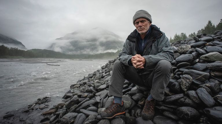 Jeremy Wade sitting on rocks by a river in Port Fidalgo, Prince William Sound, Alaska. Pic: Animal Planet