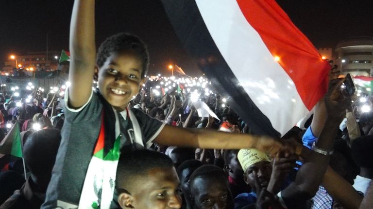 A child waves a flag at protests in the Sudanese capital of Khartoum