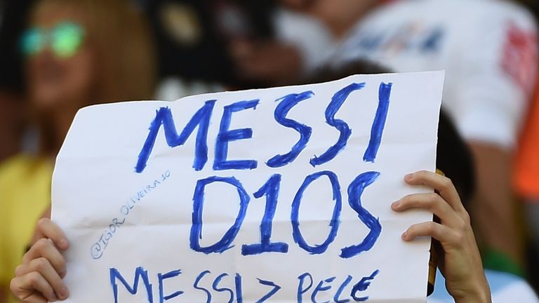 An Argentina fans holds up a banner reading in Spanish: &#39;Messi, God&#39; at the 204 World Cup