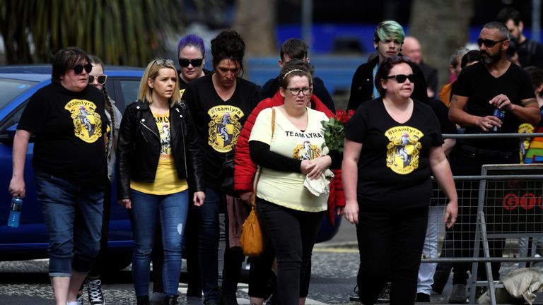 Mourners wearing Harry Potter themed shirts arrive to attend the funeral of journalist Lyra McKee