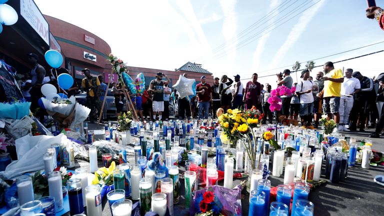 People gather around a makeshift memorial for Nipsey Hussle