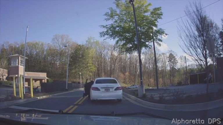 Officer dragged down by fleeing car