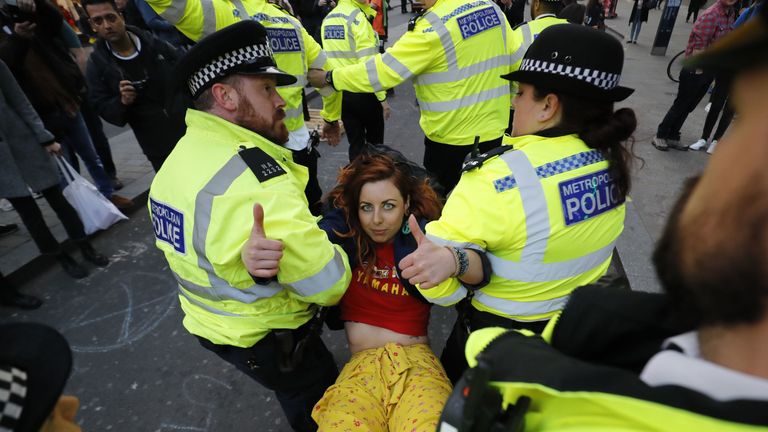 An activist is carried away in Oxford Circus