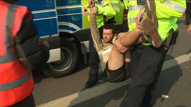 1 of hundreds of climate protesters arrested by police.