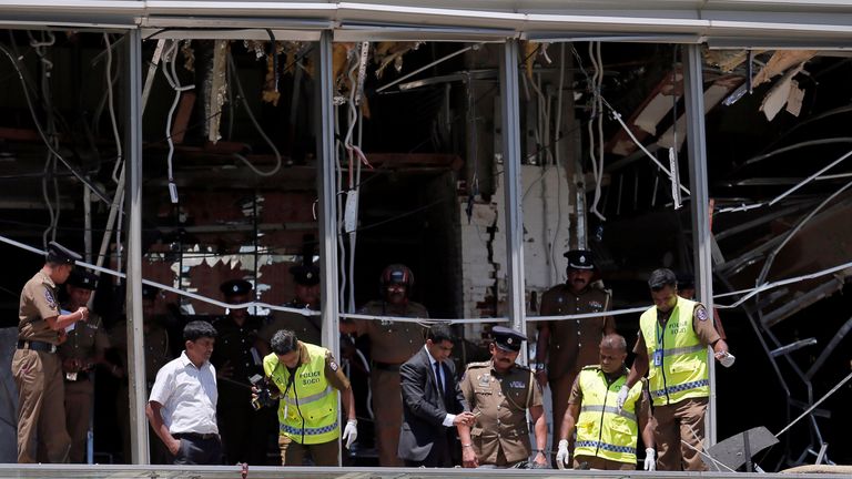 Crime scene officials inspect the explosion area at Shangri-La hotel in Colombo