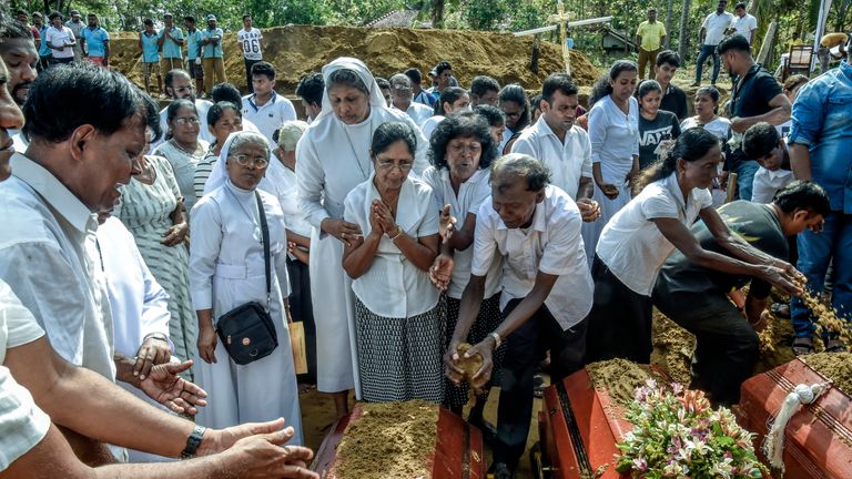 Relatives of dead offer their prayers during funeral in Katuwapity village