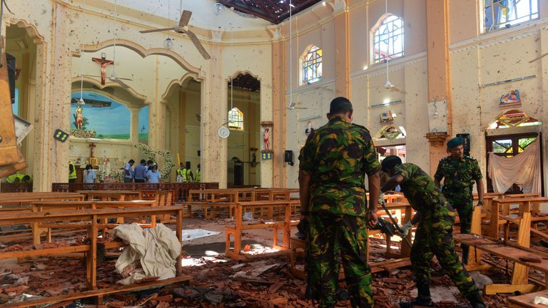 Security personnel inspect the interior of St. Sebastian&#39;s Church in Negombo