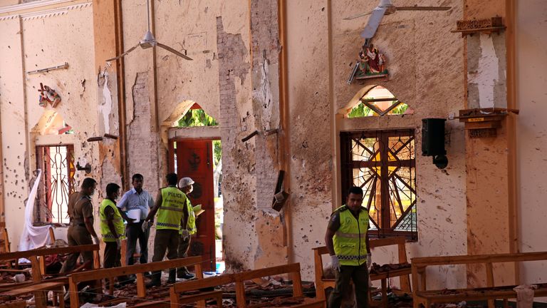 Police officers work at the scene at St. Sebastian Catholic Church, after bomb blasts ripped through churches and luxury hotels on Easter, in Negombo, Sri Lanka April 22, 2019