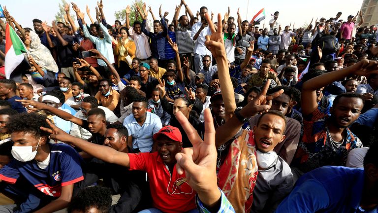 Sudanese demonstrators cheer as they attend a protest rally 