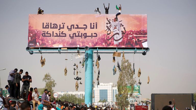 Sudanese demonstrators attend a protest rally demanding Sudanese President Omar Al-Bashir to step down outside the Defence Ministry in Khartoum