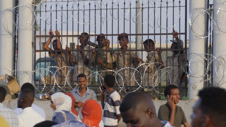 From inside the military HQ, soldiers watched the events outside through the railings