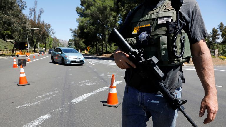 A police officer secures the area following a shooting at a synagogue in Poway