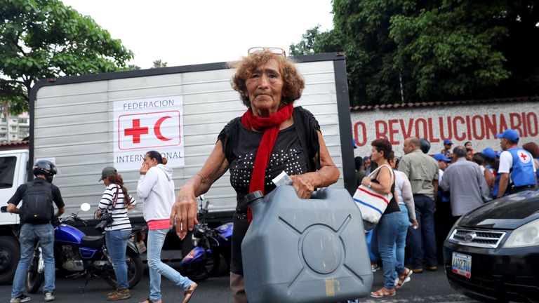 A woman carried a water container in Caracas