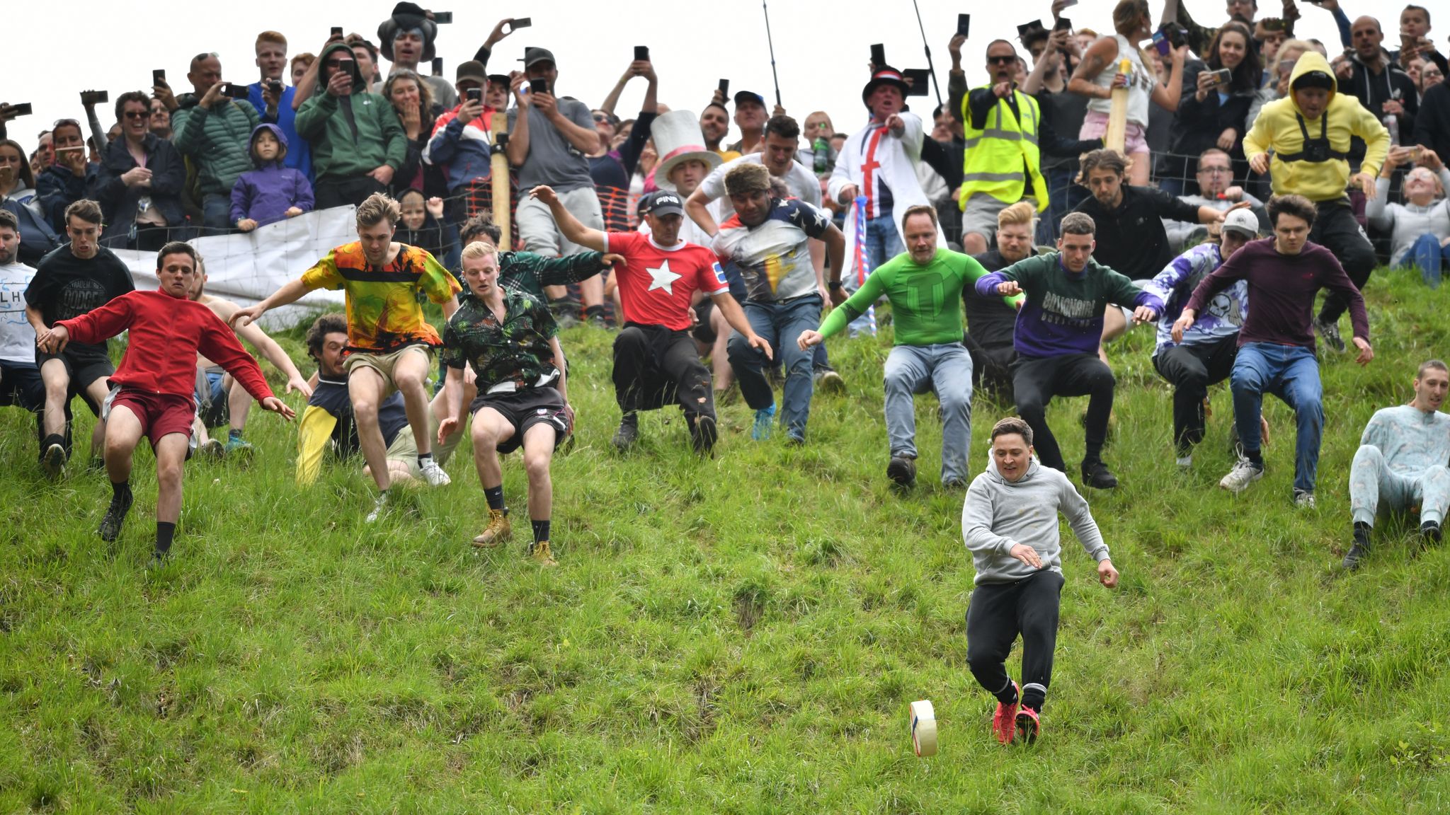 Thrill-seeking daredevils take part in annual cheese-rolling race | News | Sky News