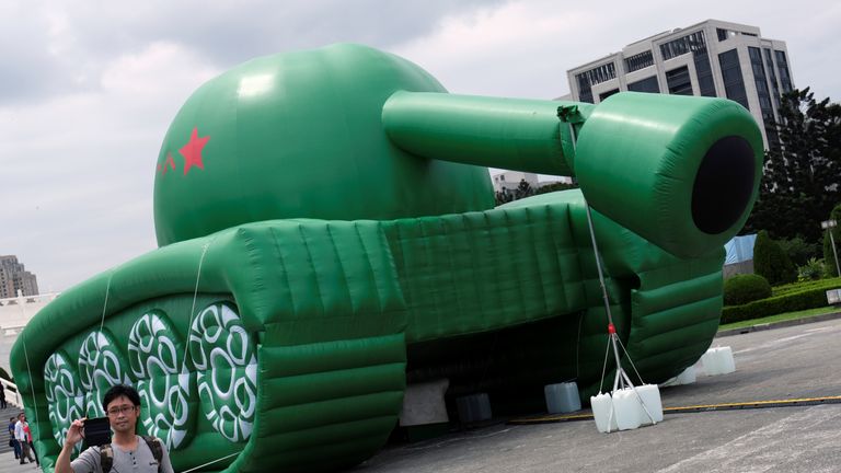 A man takes a picture in front of giant ballons in the shape of a Chinese military tank and Tank Man at the Liberty Square, ahead of June 4th anniversary of military crackdown on pro-democracy protesters in Beijing&#39;s Tiananmen Square, in Taipei, Taiwan May 21, 2019. REUTERS/Tyrone Siu