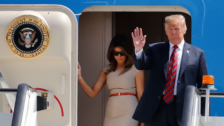 US President Donald Trump (R) waves as he disembarks Air Force One with US First Lady Melania Trump (L) at Stansted Airport, north of London on July 12, 2018, as he begins his first visit to the UK as US president. - The four-day trip, which will include talks with Prime Minister Theresa May, tea with Queen Elizabeth II and a private weekend in Scotland, is set to be greeted by a leftist-organised mass protest in London on Friday. (Photo by Tolga AKMEN / AFP)        (Photo credit should read TOLGA AKMEN/AFP/Getty Images)