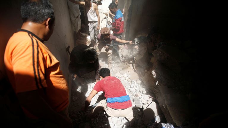 People search for survivors under the rubble at the site of an air strike launched by the Saudi-led coalition in Sanaa, Yemen on Thursday