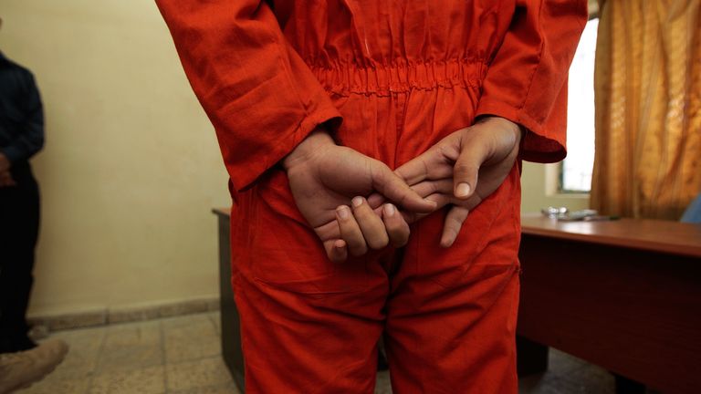 An arrested Iraqi man stands before Iraqi judges in a makeshift courtroom November 6, 2007 in Baghdad, Iraq