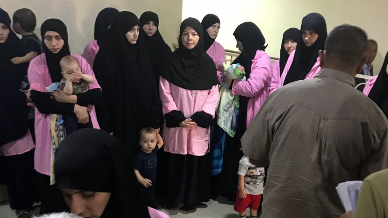 A picture taken on April 29, 2018 in the Iraqi capital Baghdad's Central Criminal Court shows Russian women who have been sentenced to life in prison on grounds of joining the Islamic State (IS) group standing with children in a hallway