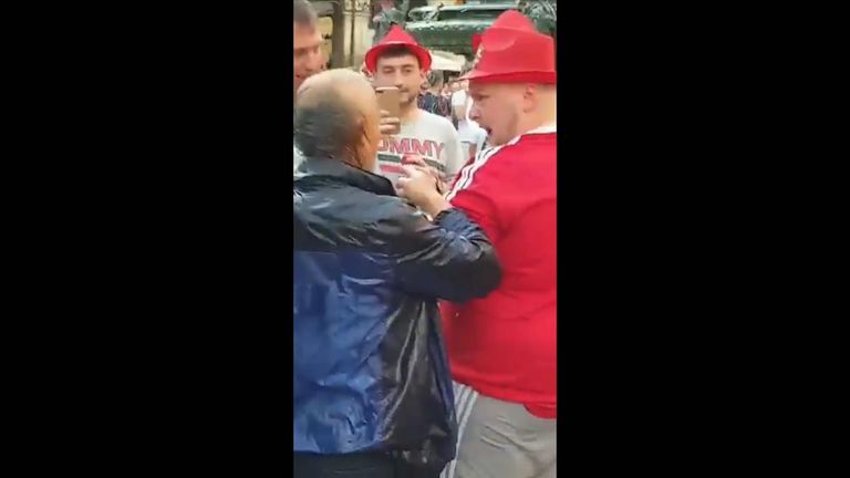 The man was dripping wet when he approached a group of laughing men in the square