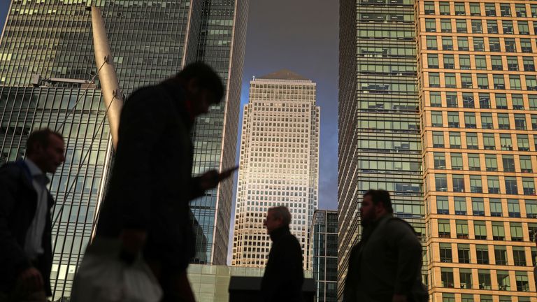 People walk through the Canary Wharf financial district of London, Britain, December 7, 2018