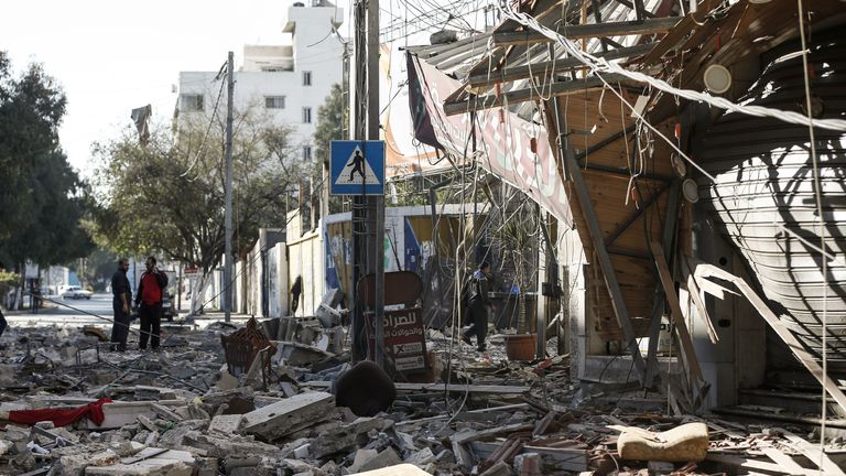 Residents gather in a debris-strewn street in Gaza City on May 5, 2019, that was hit during Israeli air strikes on the Palestinian enclave. - Gaza militants fired fresh rocket barrages at Israel early today in a deadly escalation that has seen Israel respond with waves of strikes as a fragile truce again faltered and a further escalation was feared. (Photo by MAHMUD HAMS / AFP) (Photo credit should read MAHMUD HAMS/AFP/Getty Images)
