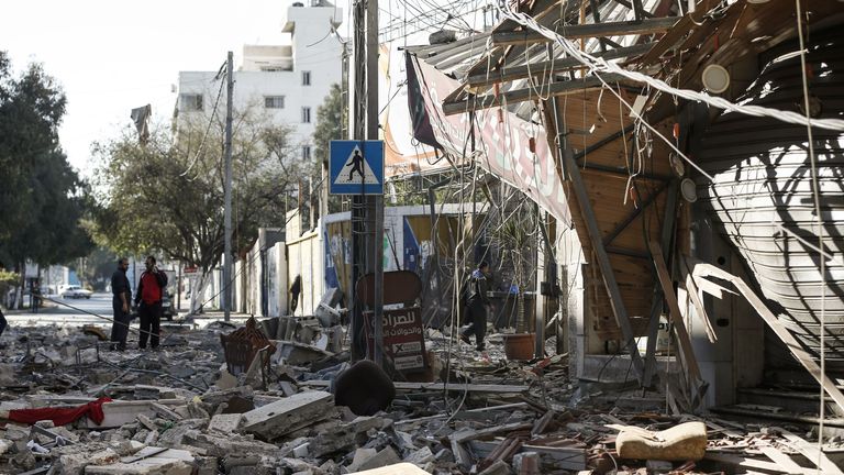 Residents gather in a debris-strewn street in Gaza City on May 5, 2019, that was hit during Israeli air strikes on the Palestinian enclave. - Gaza militants fired fresh rocket barrages at Israel early today in a deadly escalation that has seen Israel respond with waves of strikes as a fragile truce again faltered and a further escalation was feared. (Photo by MAHMUD HAMS / AFP) (Photo credit should read MAHMUD HAMS/AFP/Getty Images)