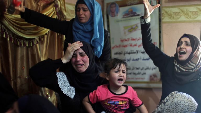 Palestinians mourn the death of a family member killed during a protest at the border between Israel and Gaza