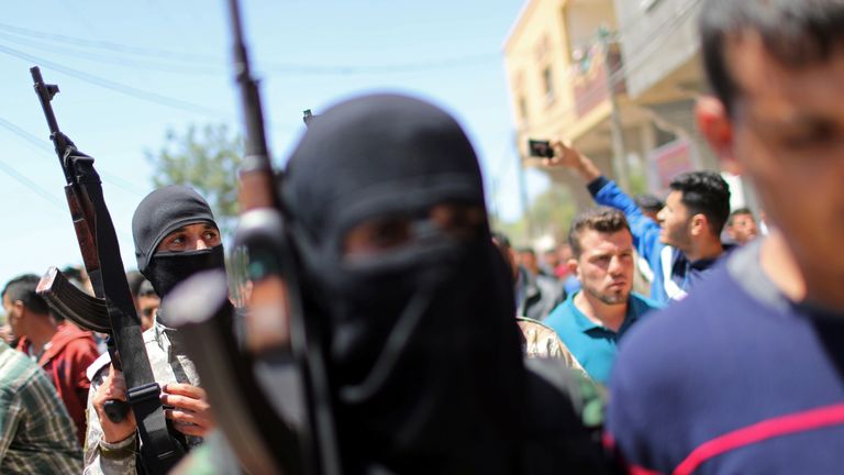 Palestinian militants take part in the funeral of a comrade killed by an Israeli airstrike