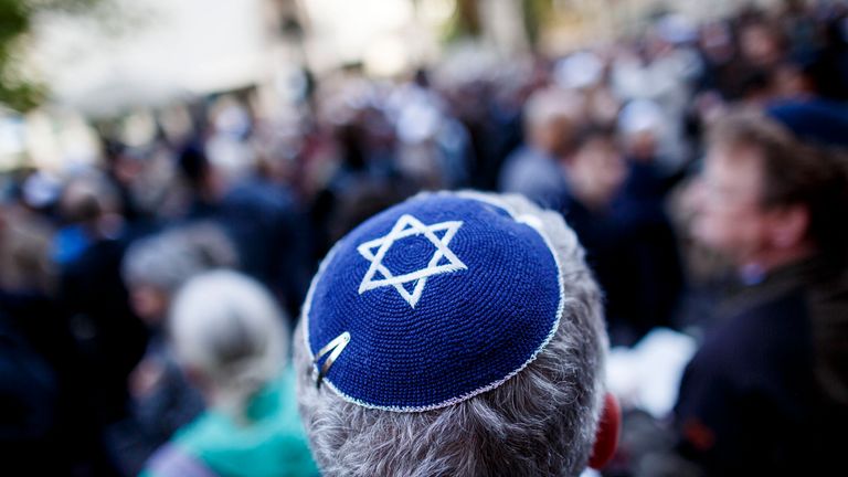 A participant wears a kippa during a "wear a kippa" gathering to protest against anti-Semitism in front of the Jewish Community House on April 25, 2018 in Berlin
