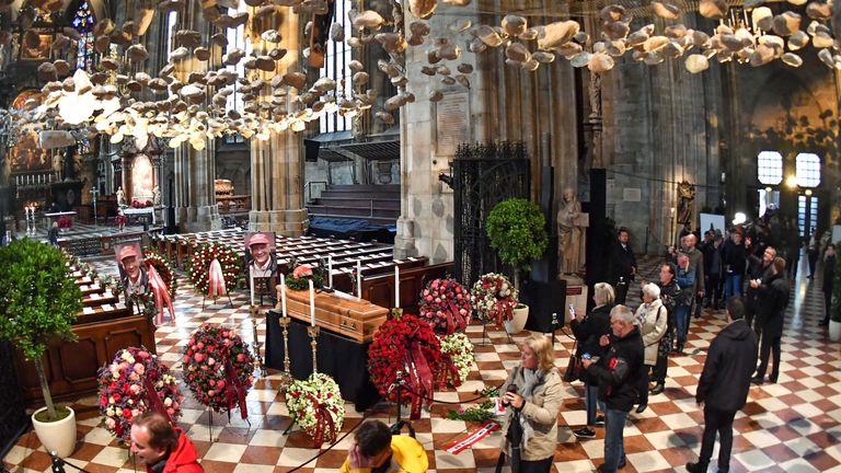 People queue to pay their respects in front of the coffin of Austrian three-time Formula One world champion