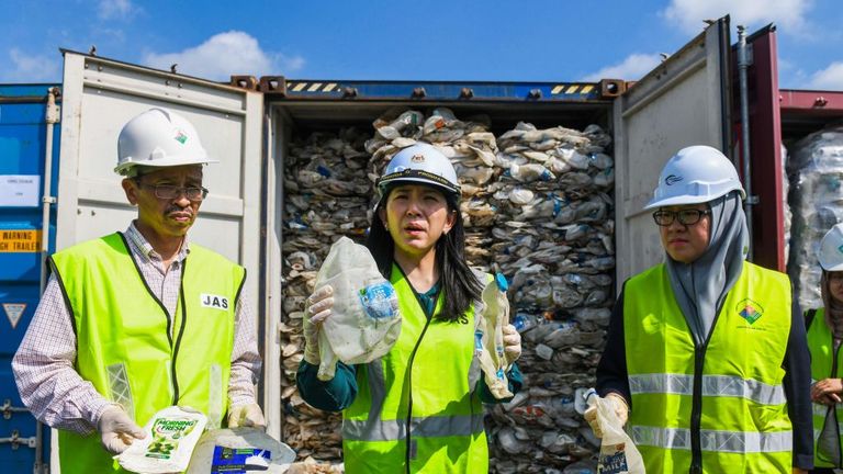 The environment minister (middle) held up some plastic water from Australia