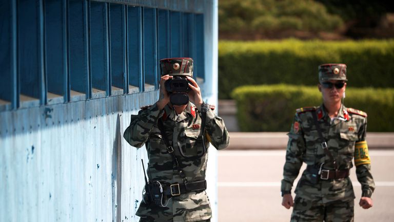A North Korean soldier keeps watch toward the south through a binocular telescope at the truce village of Panmunjom inside the demilitarized zone (DMZ) separating the two Koreas, South Korea, May 1, 2019. REUTERS/Kim Hong-Ji