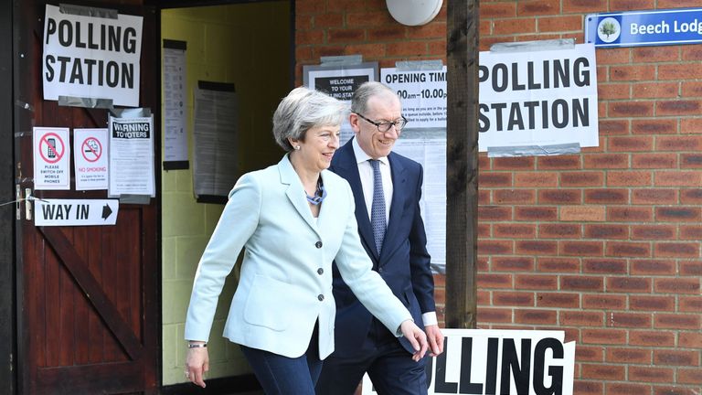 Theresa May and her husband Philip leave her local constituency polling station in Sonning, Berkshire
