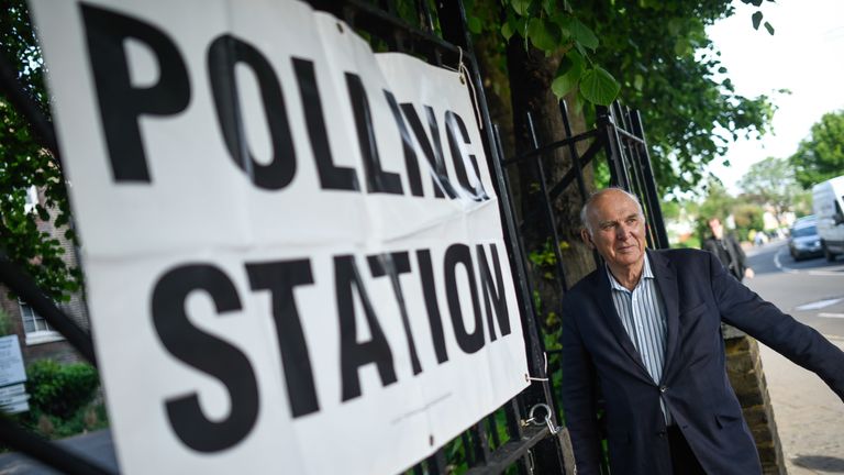 Vince Cable arrives at a polling station to vote in European Parliament elections