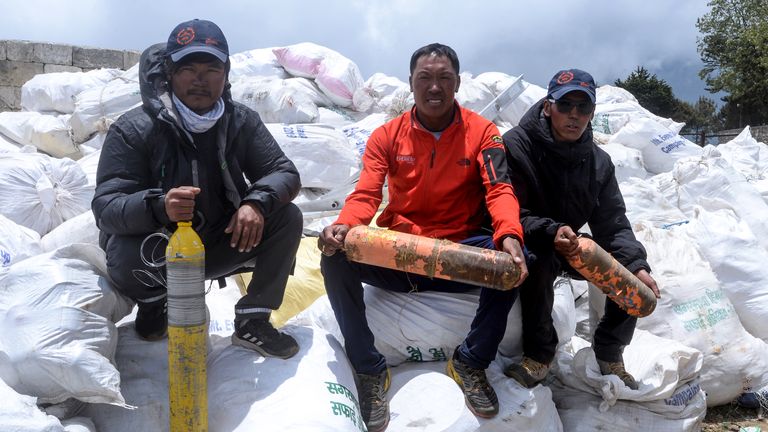 Nepali climbers pose for photographs after collecting waste from the Mount Everest at Namche Bazar, on May 27, 2019, before it is transported to Kathmandu to be recycled. - Nepal government sent a dedicated clean-up team to Mount Everest this season with a target to bring back 10,000 kilograms (10 tonnes) of trash in an ambitious plan to clean the world's highest rubbish dump. (Photo by PRAKASH MATHEMA / AFP)        (Photo credit should read PRAKASH MATHEMA/AFP/Getty Images)
