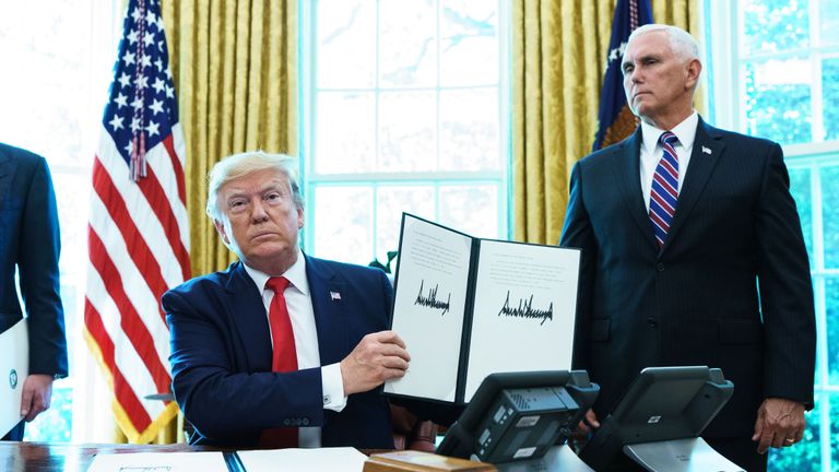 US President Donald Trump shows an executive order on sanctions on Iran&#39;s supreme leader in the Oval Office of the White House on June 24, 2019. (Photo by MANDEL NGAN / AFP)        (Photo credit should read MANDEL NGAN/AFP/Getty Images)