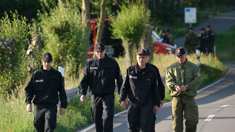NOSSENTIN, GERMANY - JUNE 24: Police walk along the road leading to the crash site of one of two Bundeswehr Eurofighter fighter jets on June 24, 2019 near Nossentin, Germany. Two Eurofighters collided during training earlier today, leaving one pilot dead. (Photo by Sean Gallup/Getty Images)