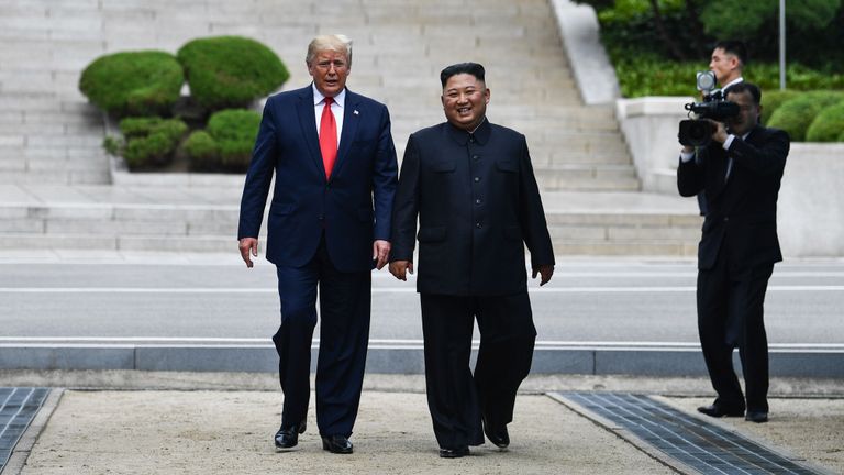 North Korea's leader Kim Jong Un walks with US President Donald Trump north of the Military Demarcation Line that divides North and South Korea, in the Joint Security Area (JSA) of Panmunjom in the Demilitarized zone (DMZ) on June 30, 2019. (Photo by Brendan Smialowski / AFP)        (Photo credit should read BRENDAN SMIALOWSKI/AFP/Getty Images)