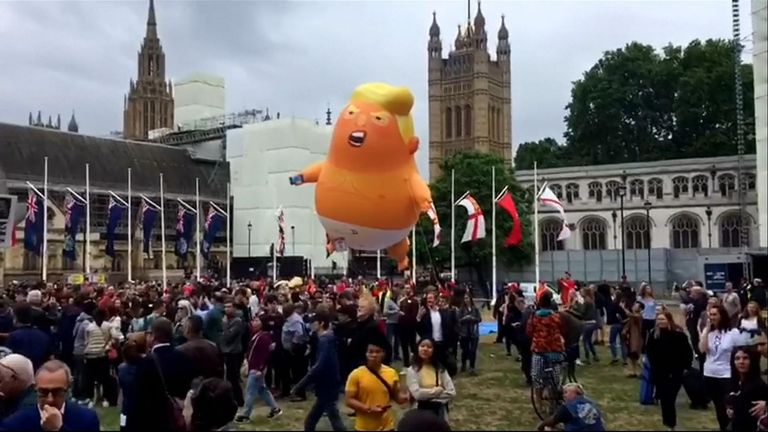 President Trump&#39;s motorcade drove past a giant inflatable blimp depicting him as a baby in central London.