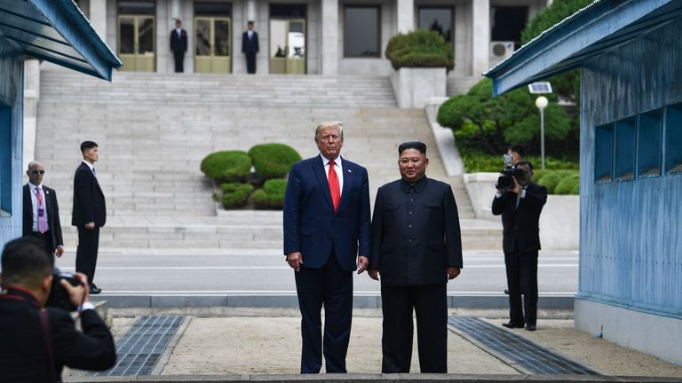 Donald Trump and Kim Jong Un stand at the military demarcation line dividing North and South Korea