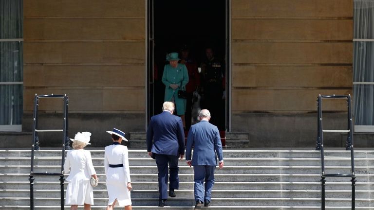Prince Charles and Donald Trump head up the steps to meet the Queen