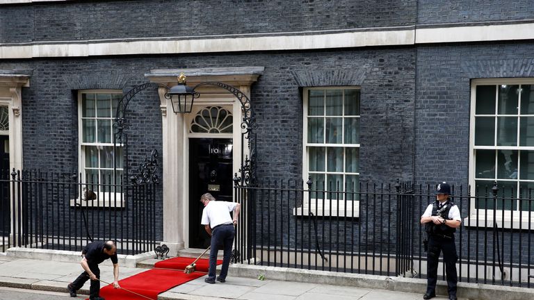 A red carpet is prepared at 10 Downing Street before Donald Trump arrives to meet Theresa May, as part of his state visit in London