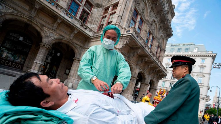 Up to three hundred supporters of the practice of Falun Dafa march through the city center of Vienna, Austria on October 1, 2018 to protest against the importing of human organs from China to Austria