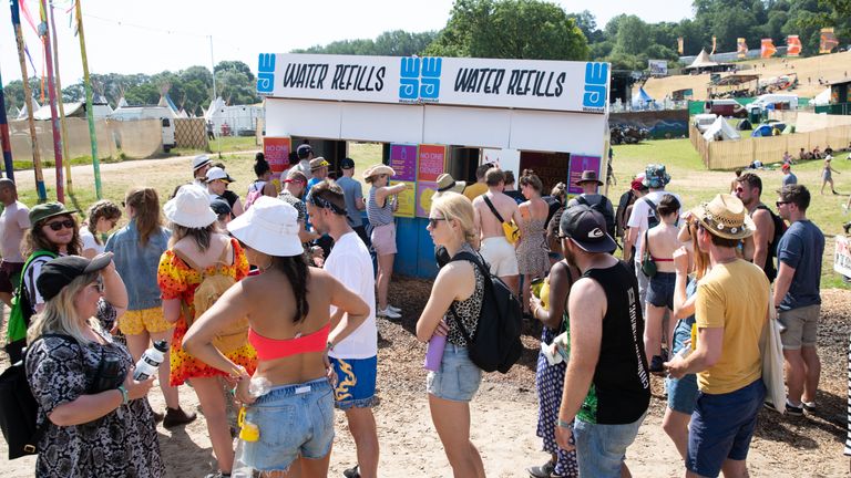 Festival goers queue for water at a refill station at the Glastonbury Festival