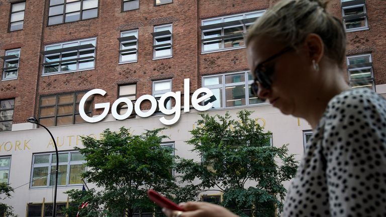 NEW YORK, NY - JUNE 3: A woman looks at her smartphone as she walks past Google Building 8510 at 85 10th Ave on June 3, 2019 in New York City. Shares of Google parent company Alphabet were down over six percent on Monday, following news reports that the U.S. Department of Justice is preparing to launch an anti-trust investigation aimed at Google. (Photo by Drew Angerer/Getty Images) 