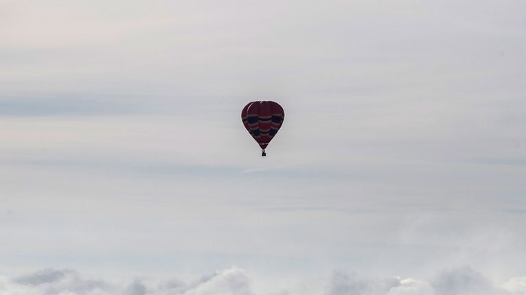 Hot air balloons fly into mist and cloud at a preview flight to launch next week&#39;s Bristol International Balloon Fiesta